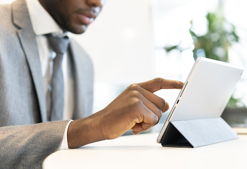 Man in suit using an electronic tablet device Man in suit using an electronic tablet device