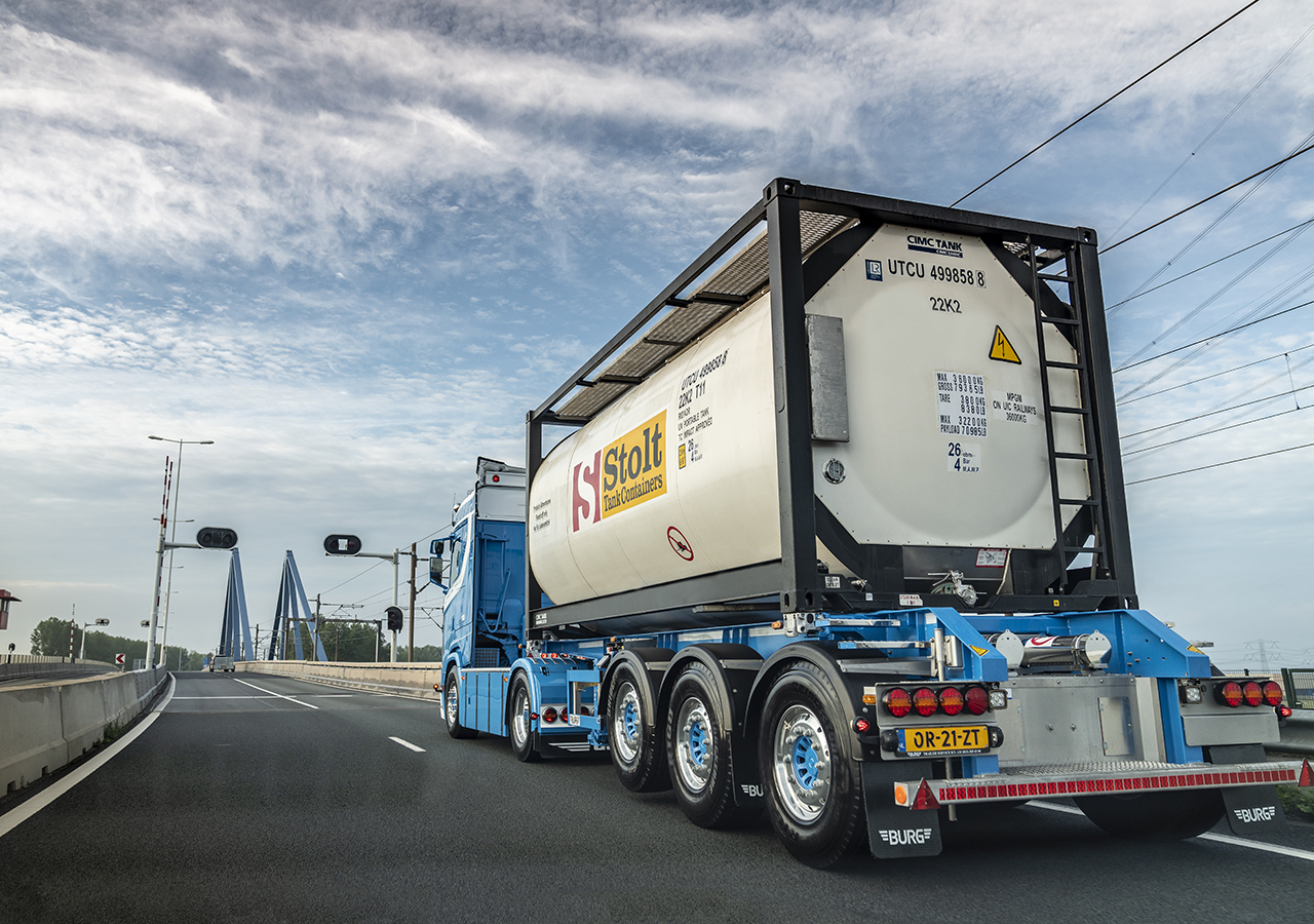 Truck with tank container driving on road