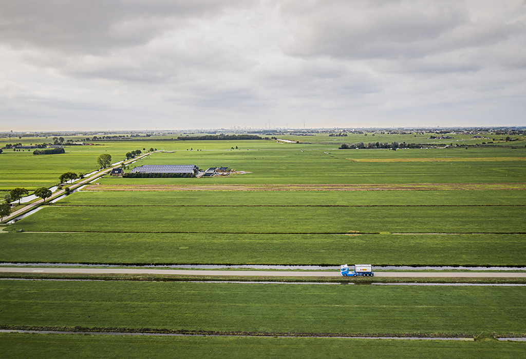 Truck with an ISO tank container driving in countryside