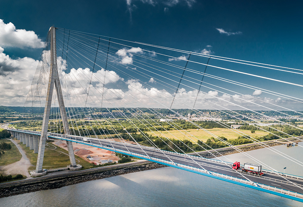 Truck with Stolt Tank Containers ISO tank container driving on a bridge