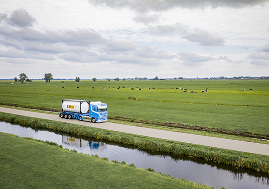 Truck with Tank Container in green field